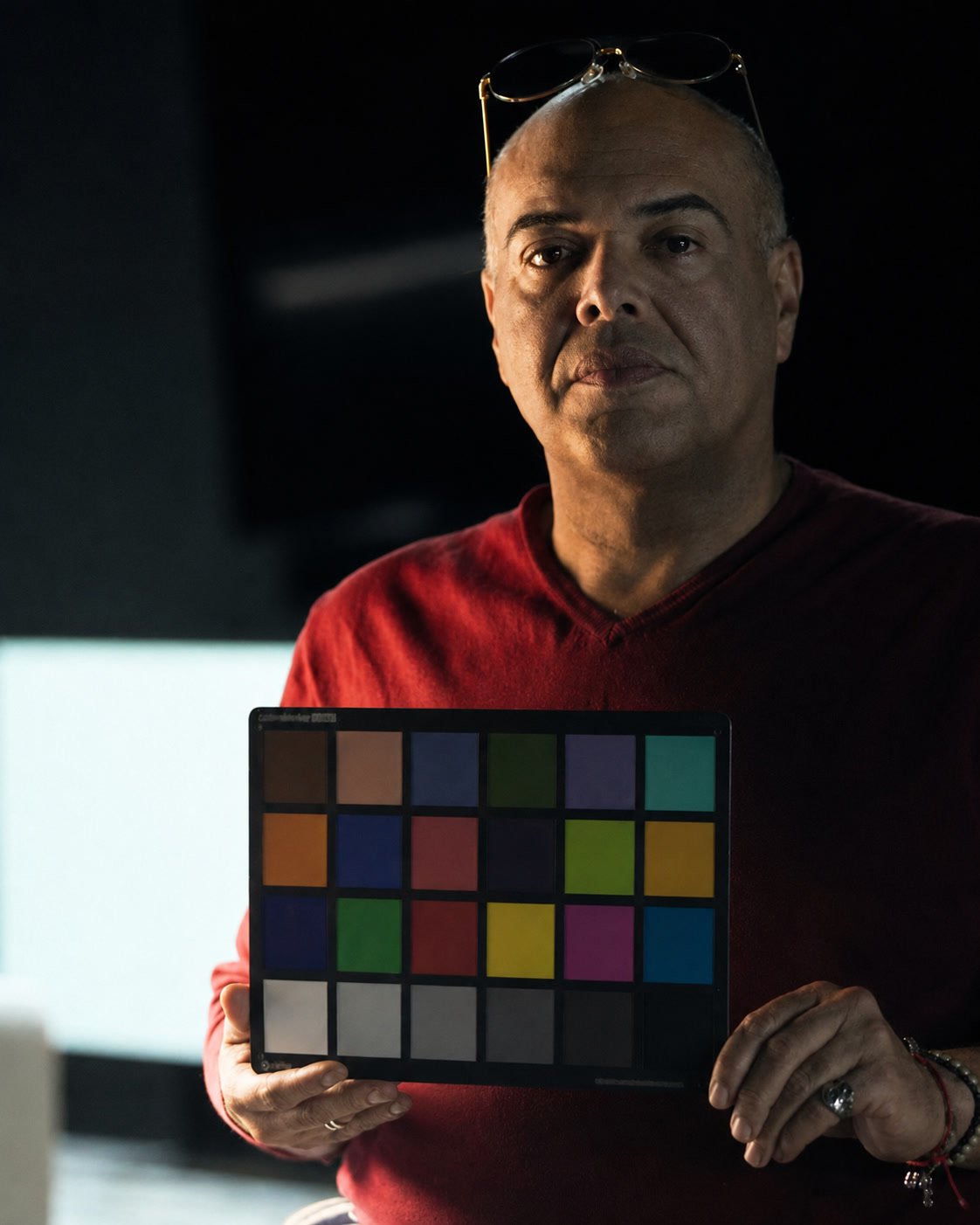 Gary Homs on a film set holding a color chart